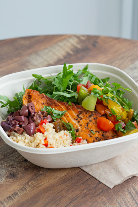 a salmon bowl in a biodegradable bowl