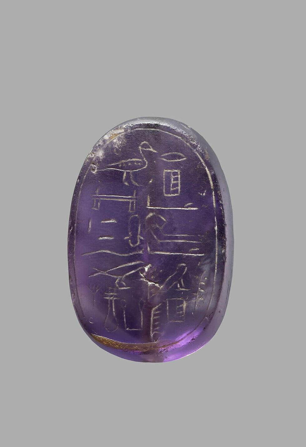 Amethyst scarab inscribed with hieroglyphs.