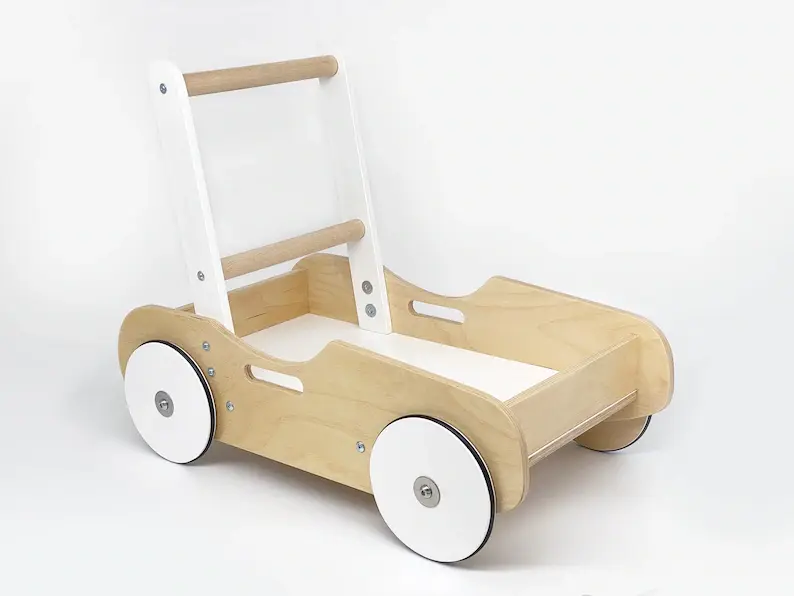A white and natural wooden baby push toy on a white floor.