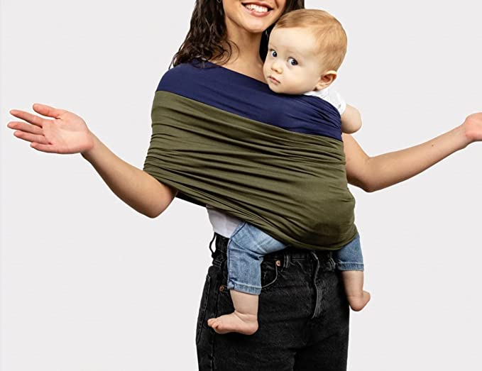 A mom with her hands out to the side showing how her TKKOK baby sling is able to hold her baby snugly.