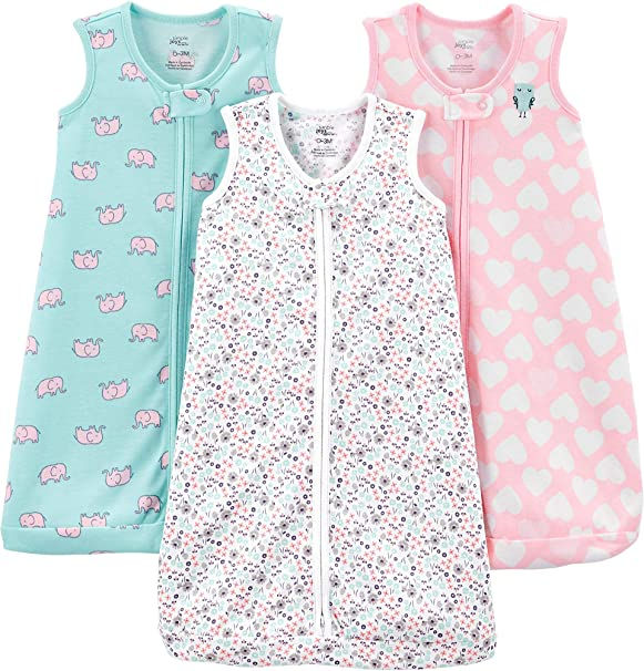 Three carters sleep sacks next to each other in pink, blue, and white.
