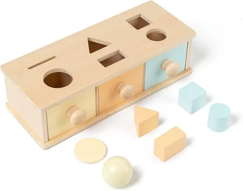 A wooden shape sorter toy with a ball, triangle, and square.