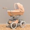 A beige baby bassinet stroller on a gray background.