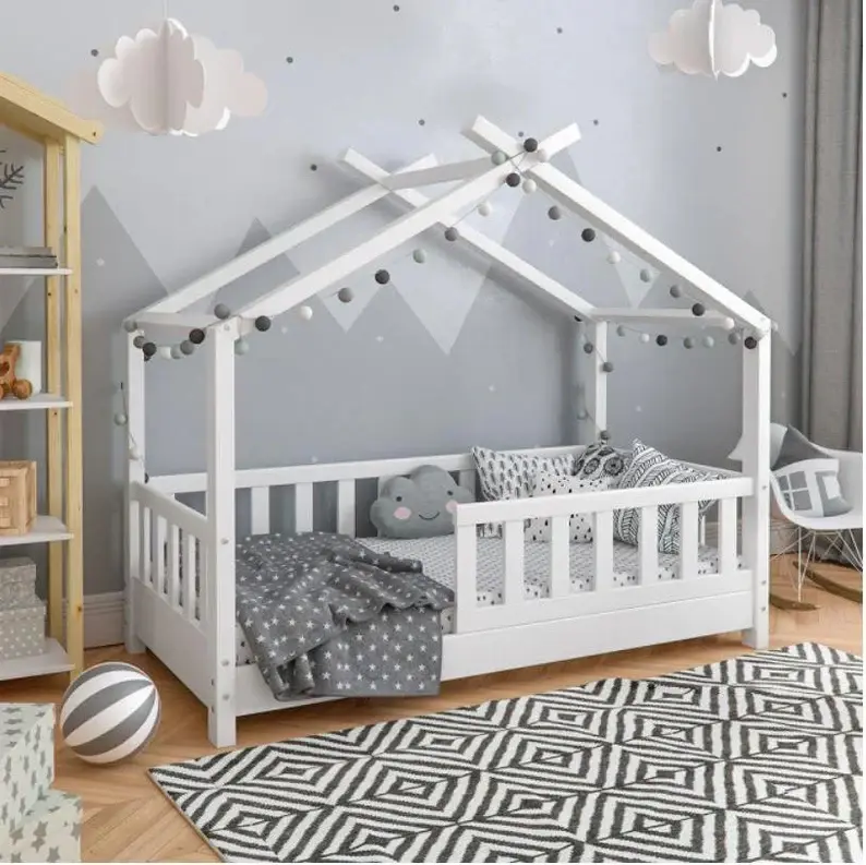 A toddlers room featuring a gray wall, white montessori floor bed, black and white rug, and fake clouds.