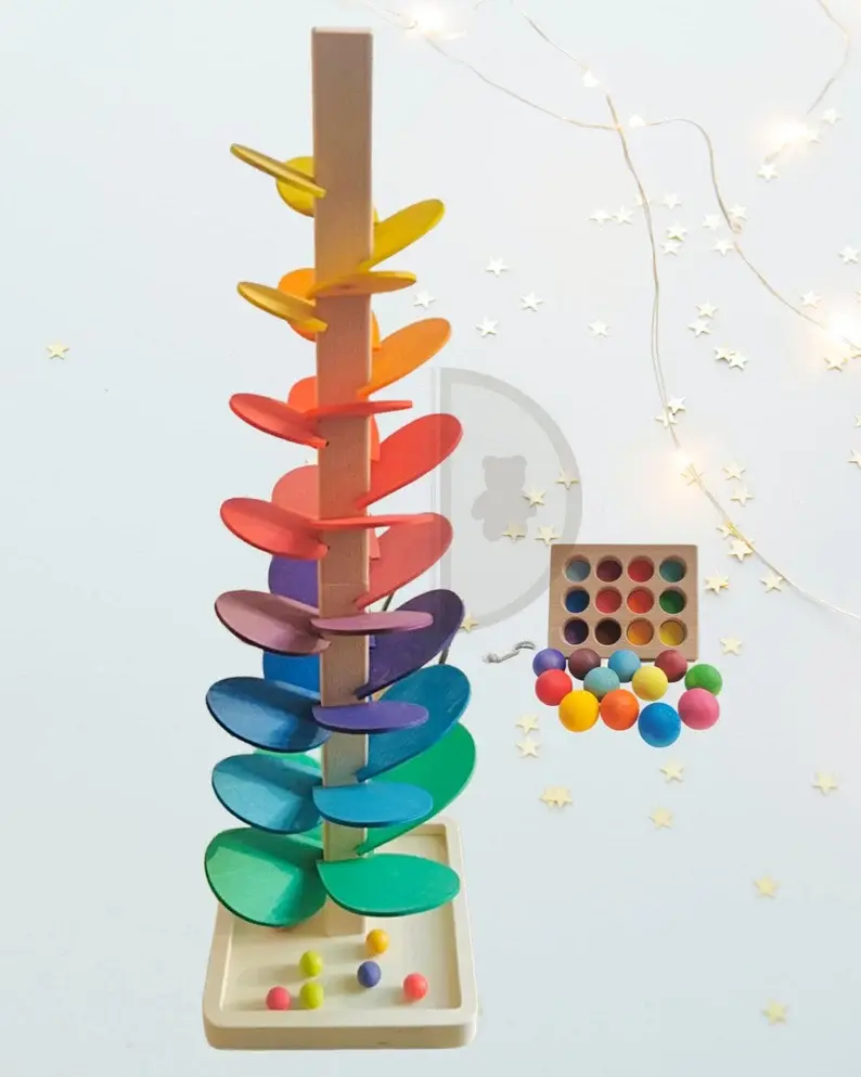 A rainbow montessori tower with marbles.