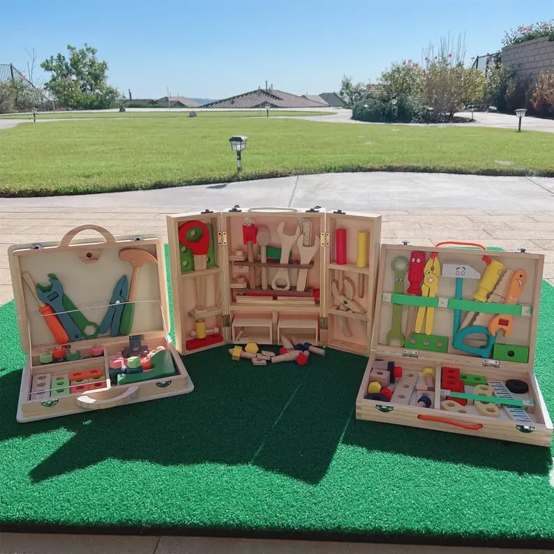 Three wooden toddler toyboxes sitting outside.