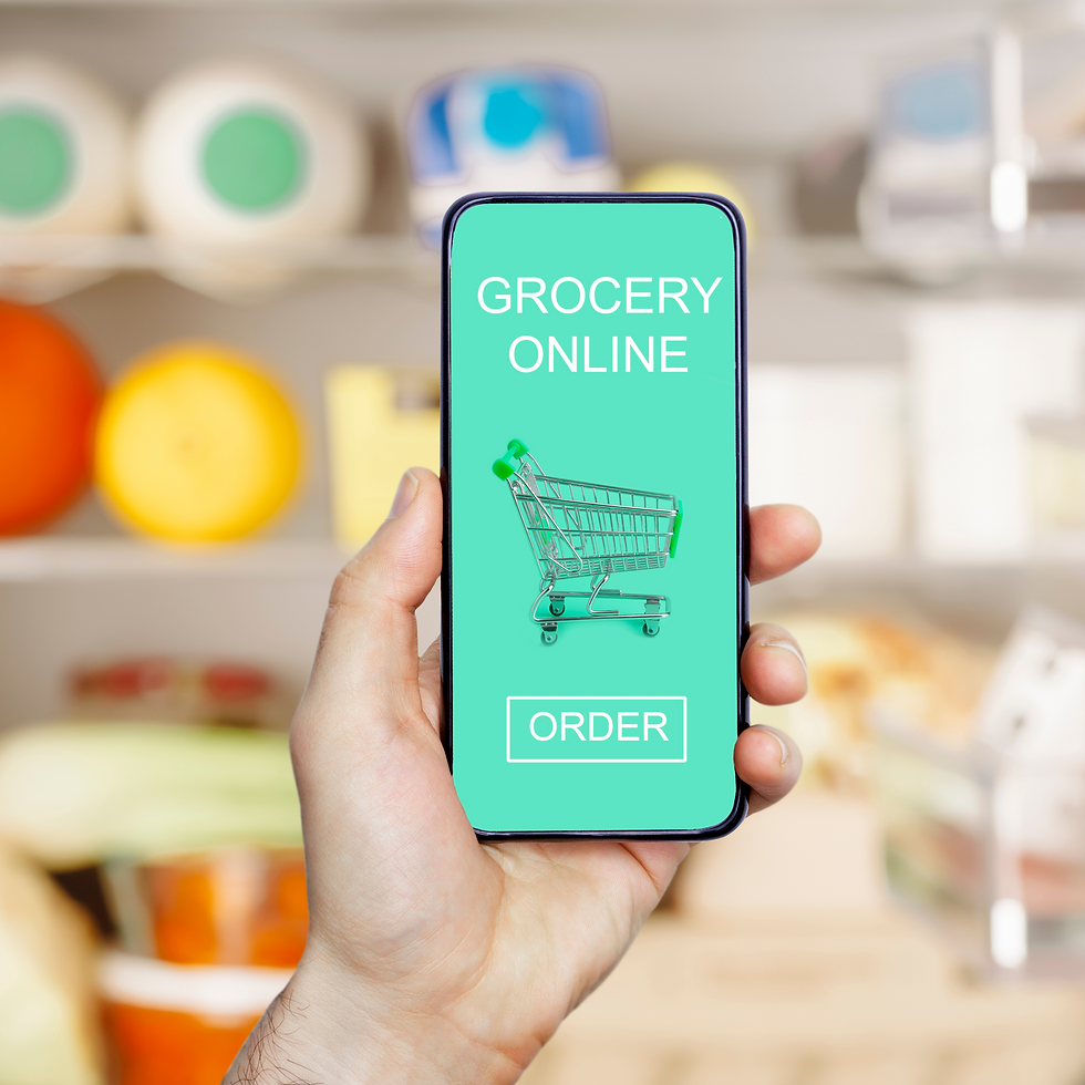 A hand holding up a phone with a grocery online order page showing.