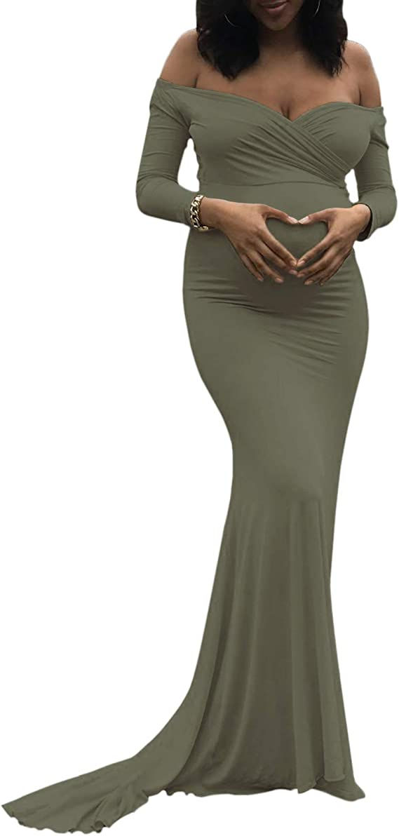 A woman making a heart with her hands over her pregnant belly.