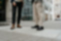 Two people standing outside a building in business casuel attire