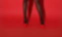 Red high heels against a red background