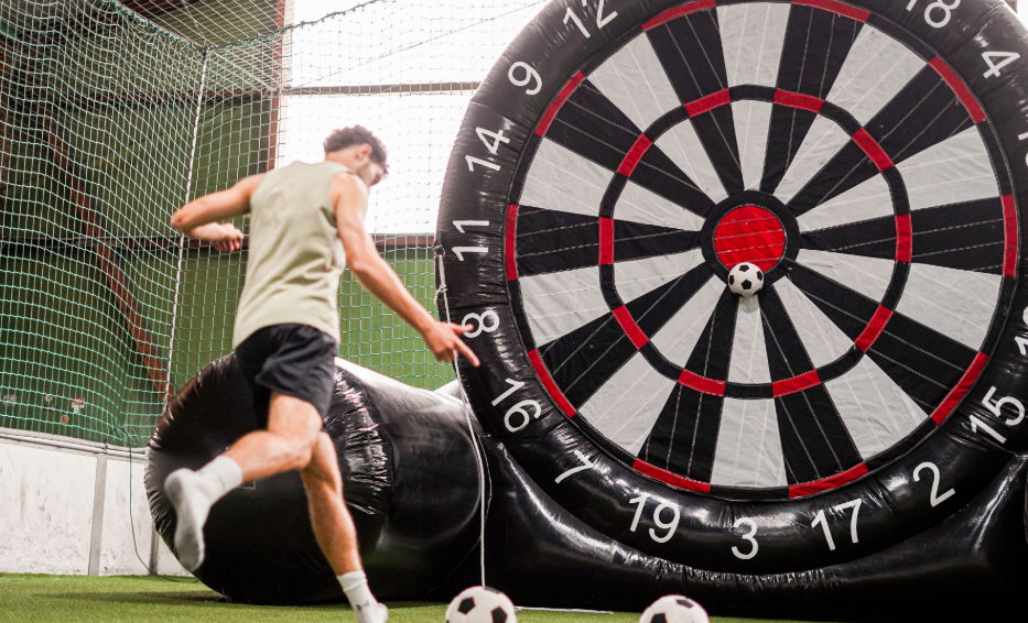 Spieler beim Fußballdart in der SoccerWorld Köln beim Zielen auf die Dartscheib