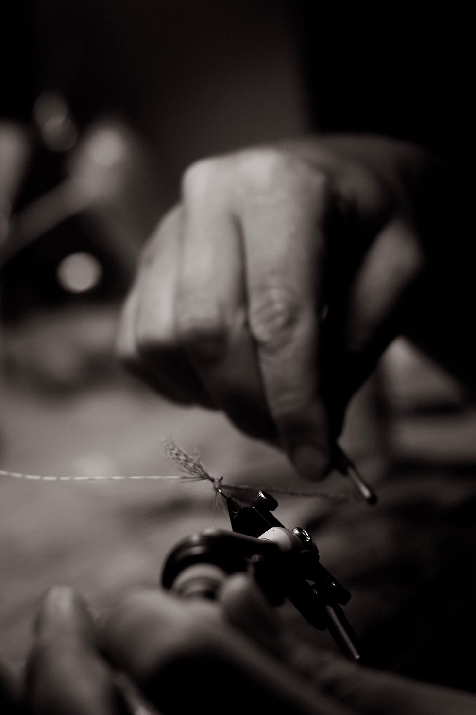 Close-up of hands tying a fishing fly for a fly tying journal