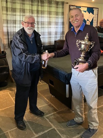 Nick Wingfield presenting Malcolm Baker with the trophy and wine.