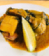 Yellow curry of salmon, with zucchini, spinach and potato