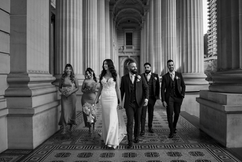 Black and white photo of bridal party with bride and groom in the middle and 2 groomsmen and 2 bridesmaids at Parliament House.