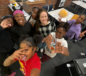 Izzy with kids at KAIROS Academies