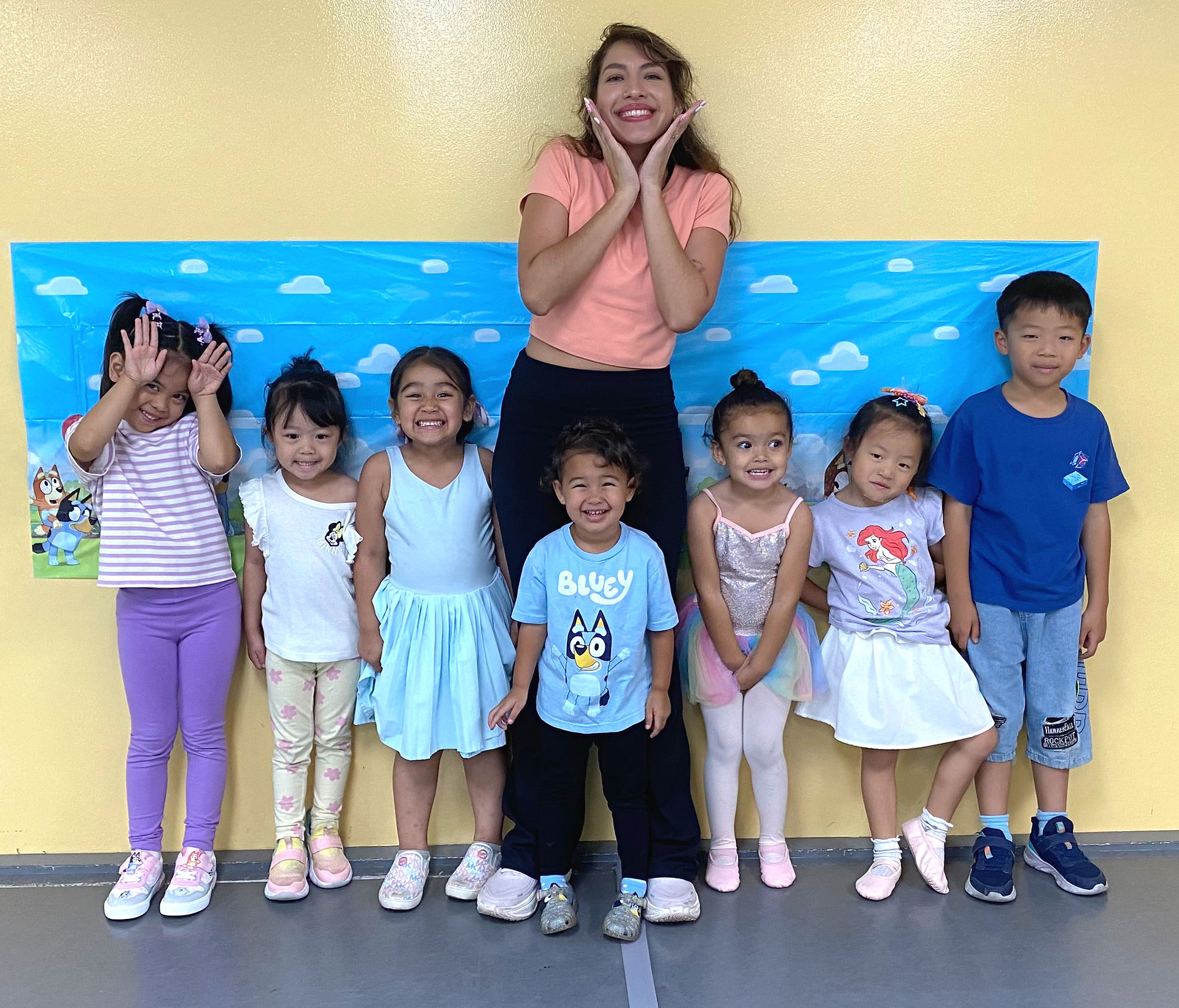 Summer campers sharing a group photo after a day of dancing and crafts.