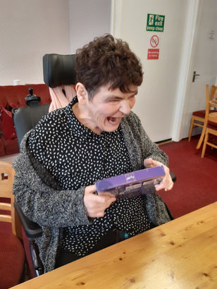 tenant receiving her chocolates from the raffle