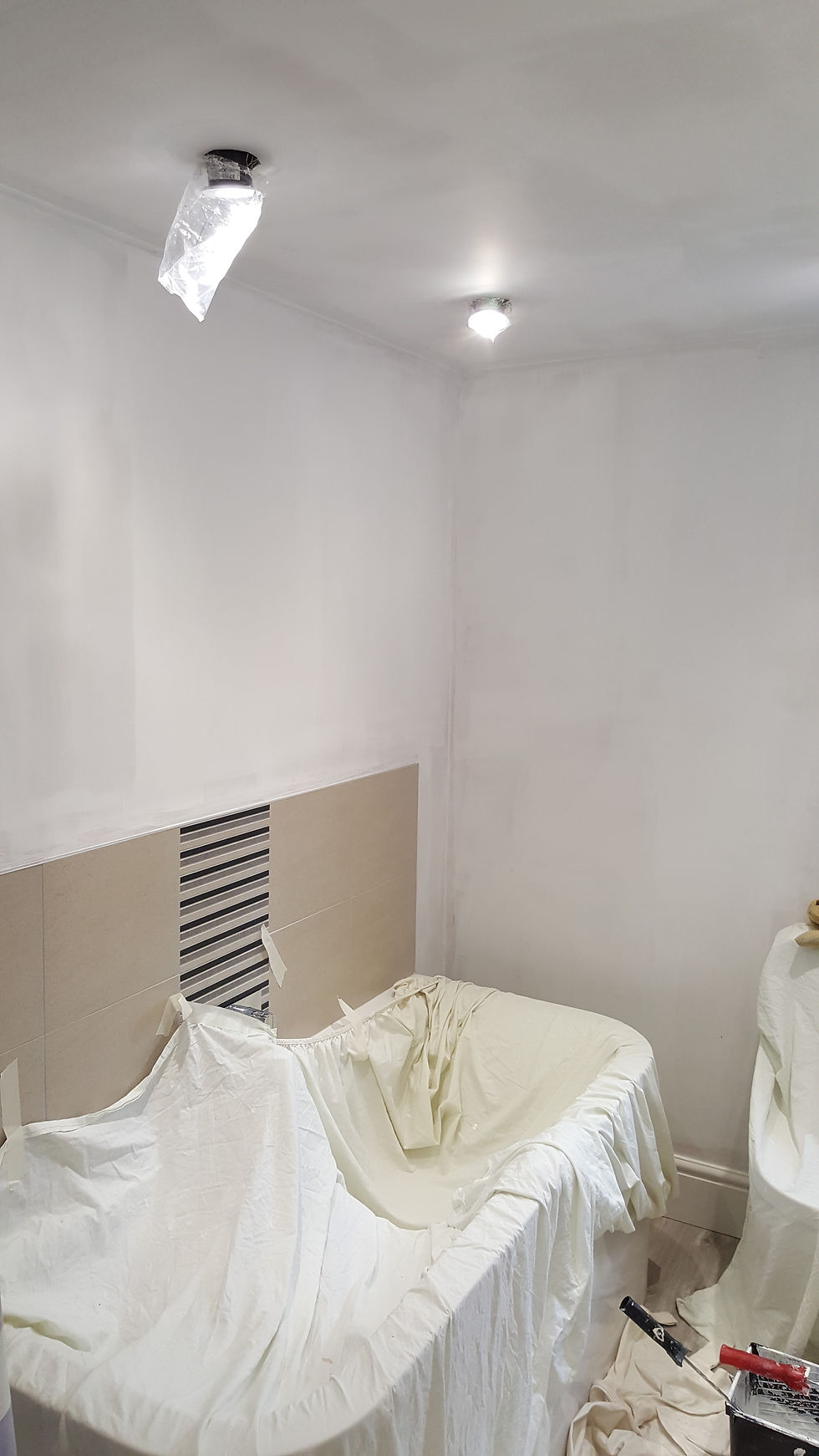 Ensuite new plaster given first coat thin wash.