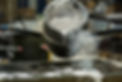Detail of metal casting, pouring molten aluminum silver colored liquid into a mold creatin
