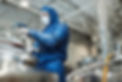 Side view portrait of male worker wearing protective gear opening tank at chemical plant o