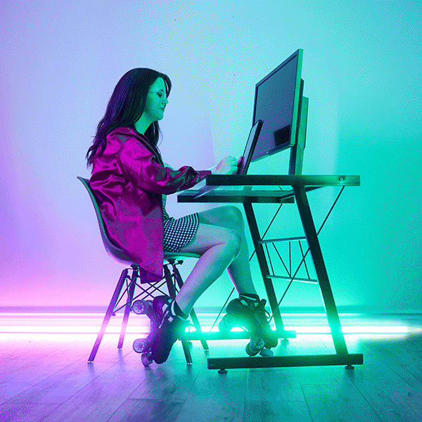 Melissa Deschenes working at a computer on roller skates