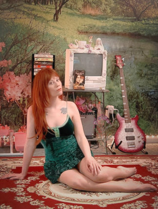 Me sitting in my room in front of my VCR which is displaying the tape of Practical Magic whilst i'm wearing the green dress