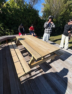 Group gathered around a picnic table they built