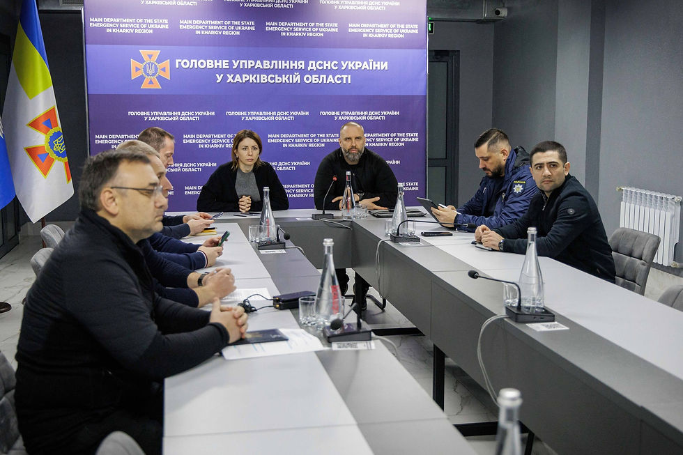About eight people, two in emergency-service uniforms, at a meeting table in the State Emergency Service's Kharkiv regional office. File photo, November 2025.