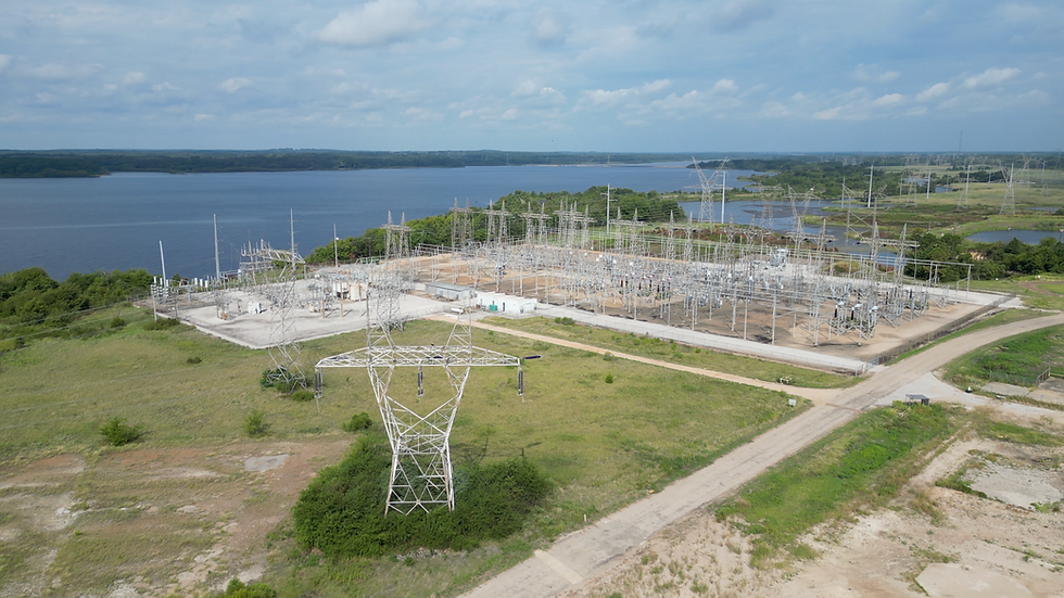Wide angle view of a substation with adjacent large-acreage powered land