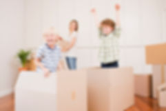 Kids jump out of moving boxes while mom packs up the old kichen in anticiaption for her new kitchen cabinets from click cabints