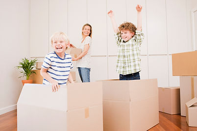 Kids jump out of moving boxes while mom packs up the old kichen in anticiaption for her new kitchen cabinets from click cabints