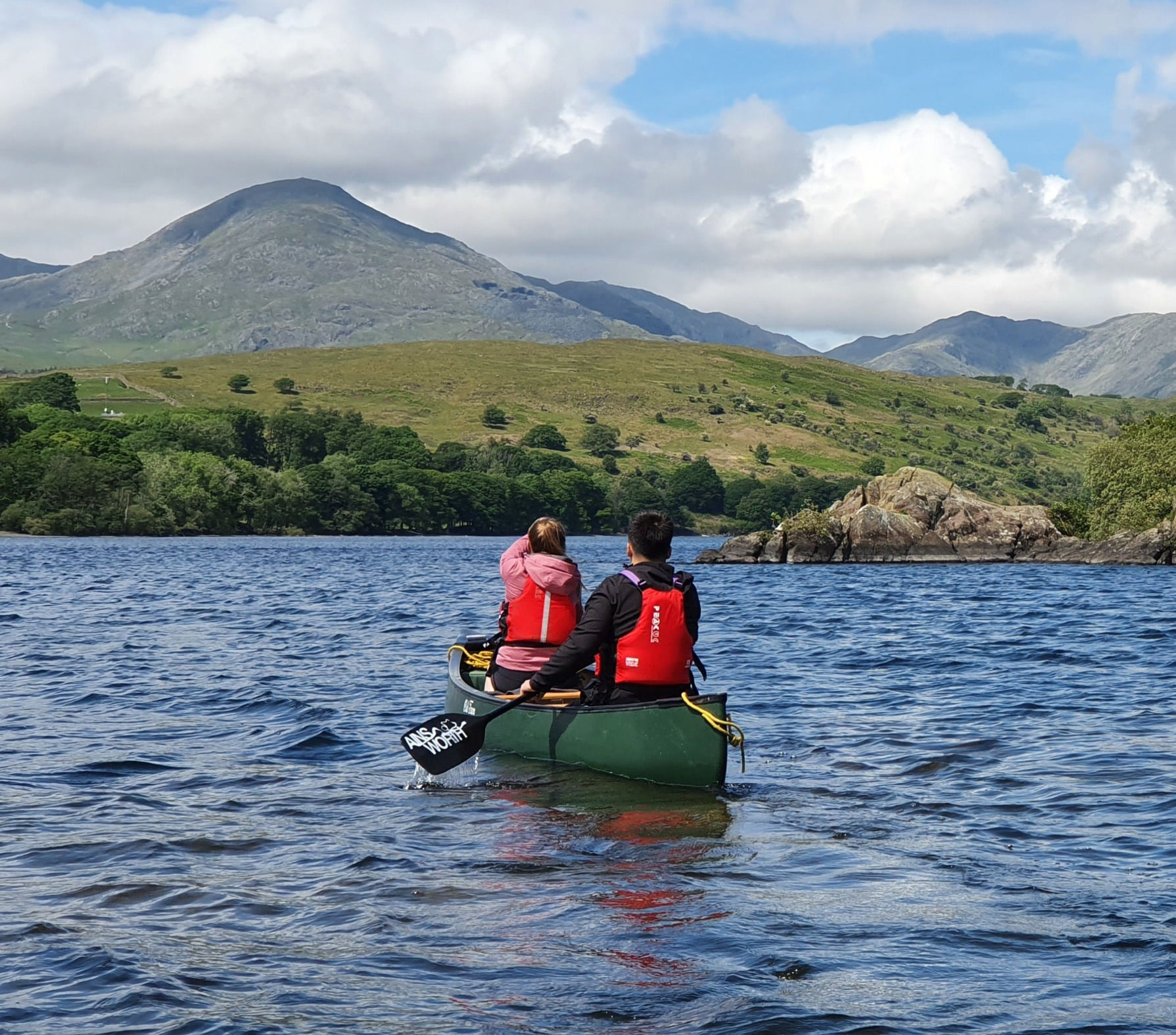Two people in a Canoe with the Old Man of Coniston in the background