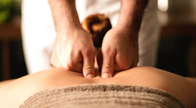 Massage therapy on the trapezius and paraspinal muscles