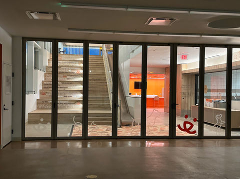 6 window panes with cut vinyl graphics of a dog and a cat walking in line across the bottom leading to the best friends logo.