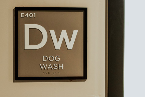 "Dw - Dog Wash" room sign, mimicking the design and layout of an element from the periodic table.