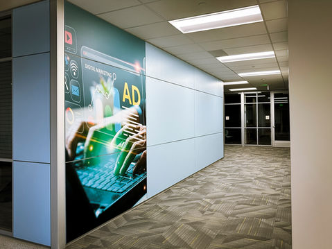 Printed vinyl wall graphic of hands typing on a laptop with a hologram display.