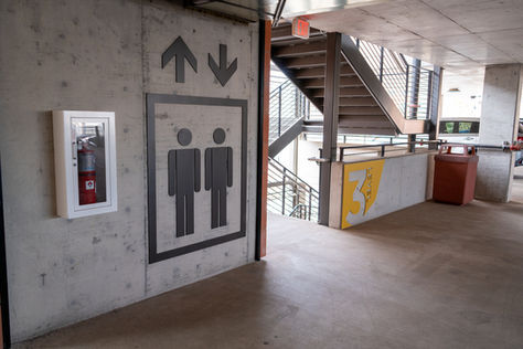 Painted metal elevator signage and floor level indication. 