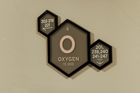 "O - Oxygen" in large hexagon, with room number wayfinding in two smaller attached hexagons