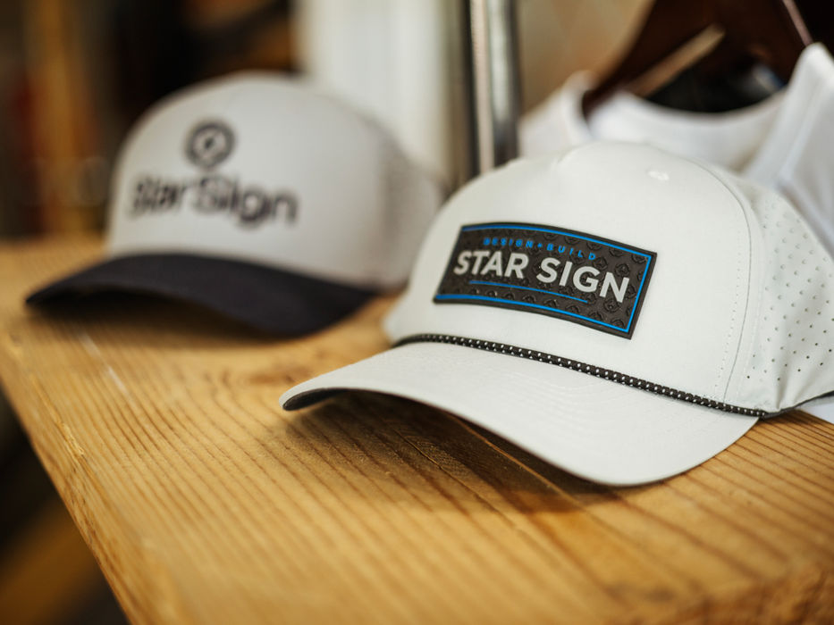 Star Sign branded patches on a nylon baseball cap and a canvas baseball cap.