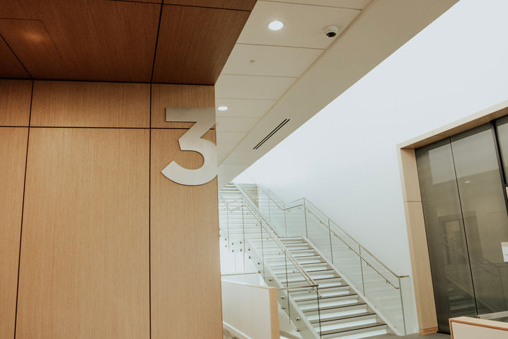 Large number "3" cut aluminum floor ID, mounted to upper right edge of the wall.