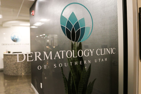 "Dermatology Clinic of Southern Utah" with a stylized blue lotus emblem. Vinyl applied to glass entrance swinging door