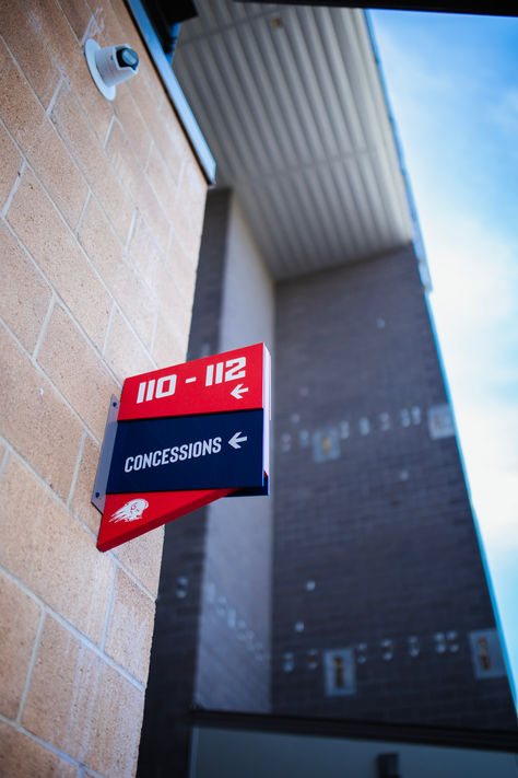 "Concessions" wayfinding blade sign, red and blue custom geometric sign.