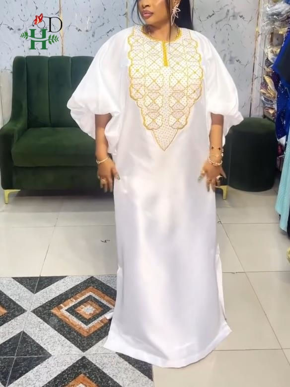 White boubou africain with traditional gold embroidery