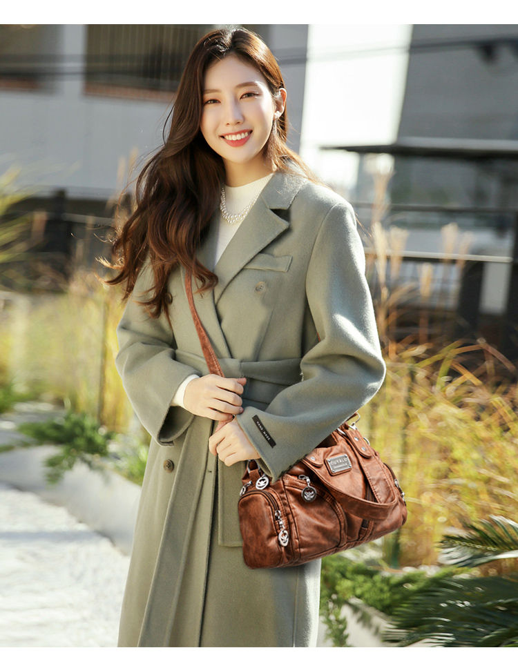 Thumbnail: Woman wearing a brown designer crossbody handbag