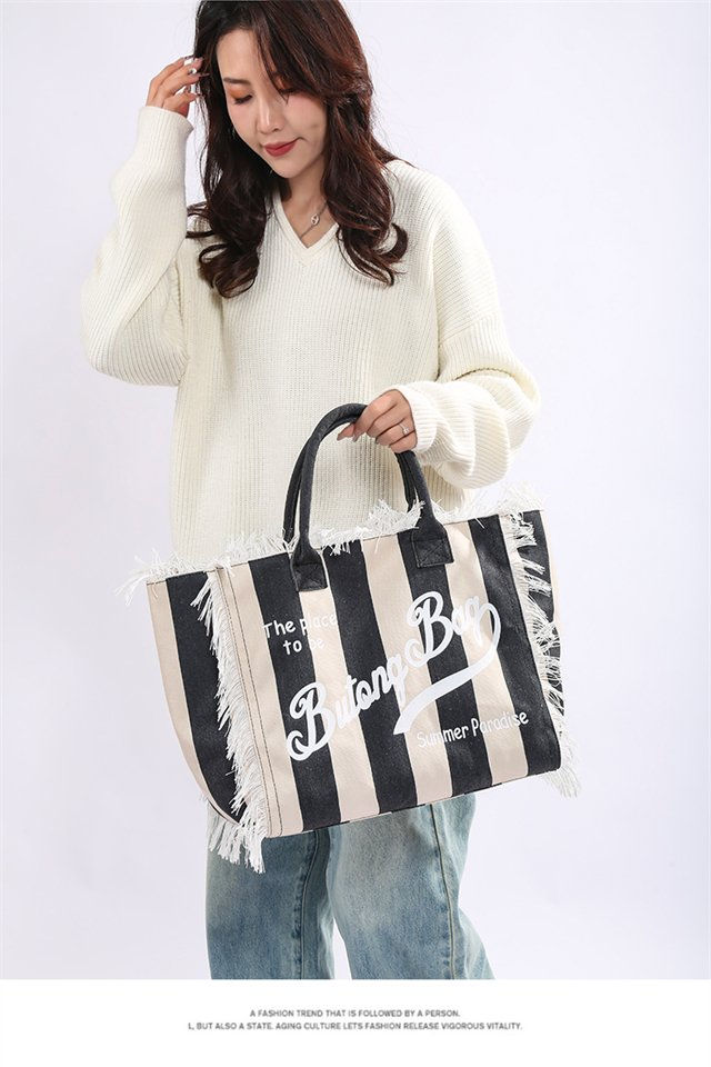 Thumbnail: Striped designer diaper bag with black and white patterns
