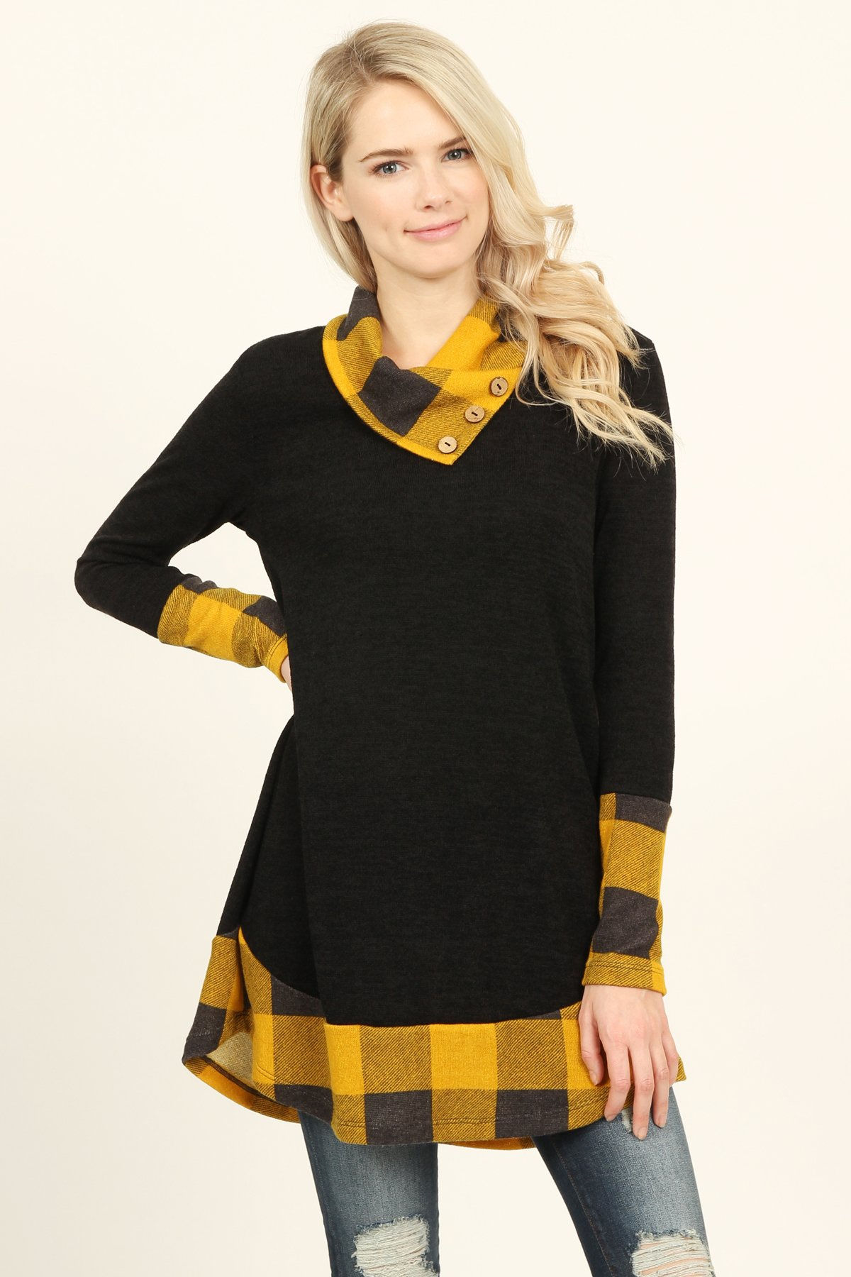 Woman wearing a black top with yellow plaid accents and a stylish collar Adine