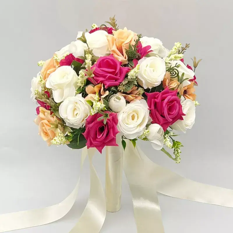 Floral bouquet with white, pink, and peach flowers tied with long ribbons. Adine.