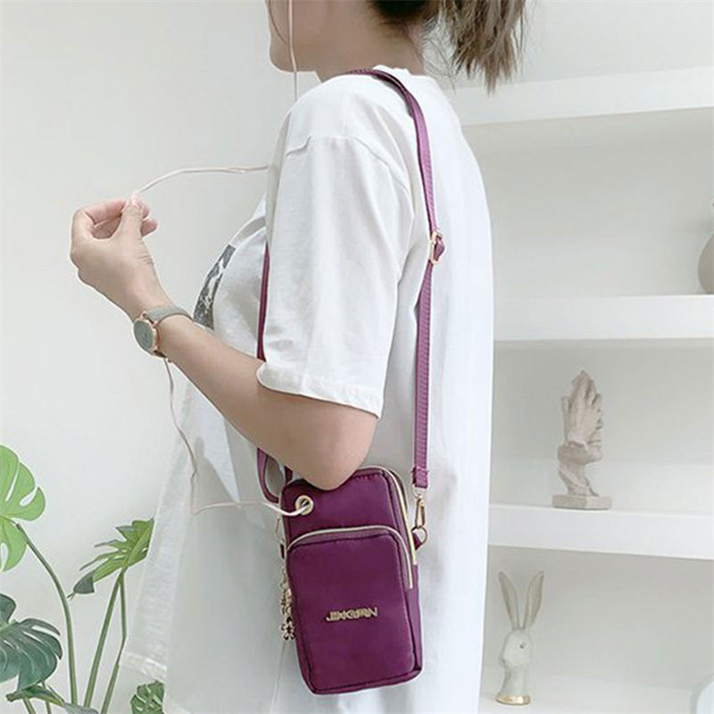 Thumbnail: Woman wearing a purple waterproof nylon crossbody bag.