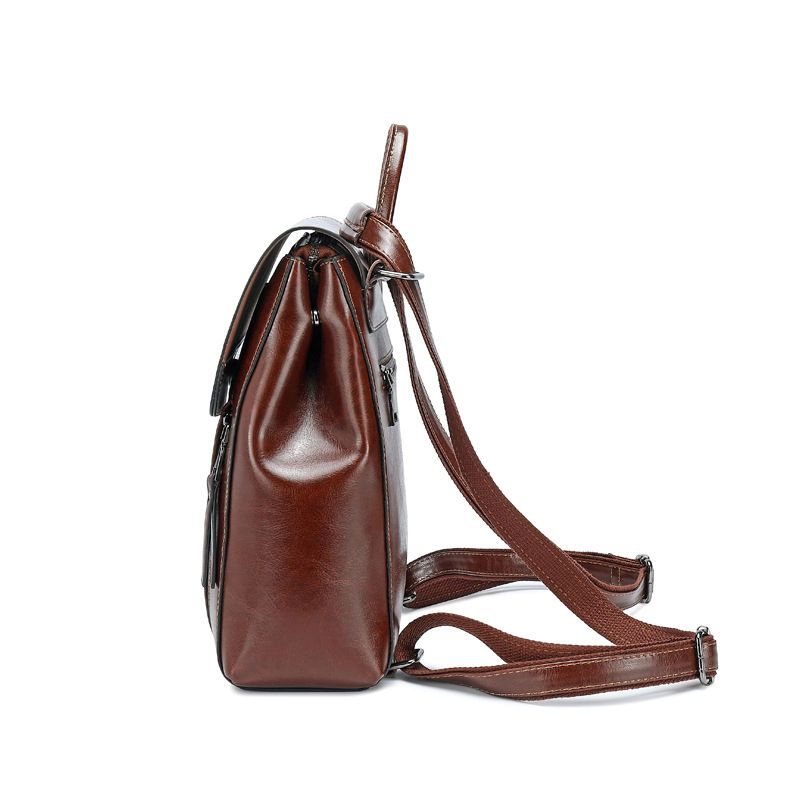 Thumbnail: Side view of a brown leather backpack with adjustable straps